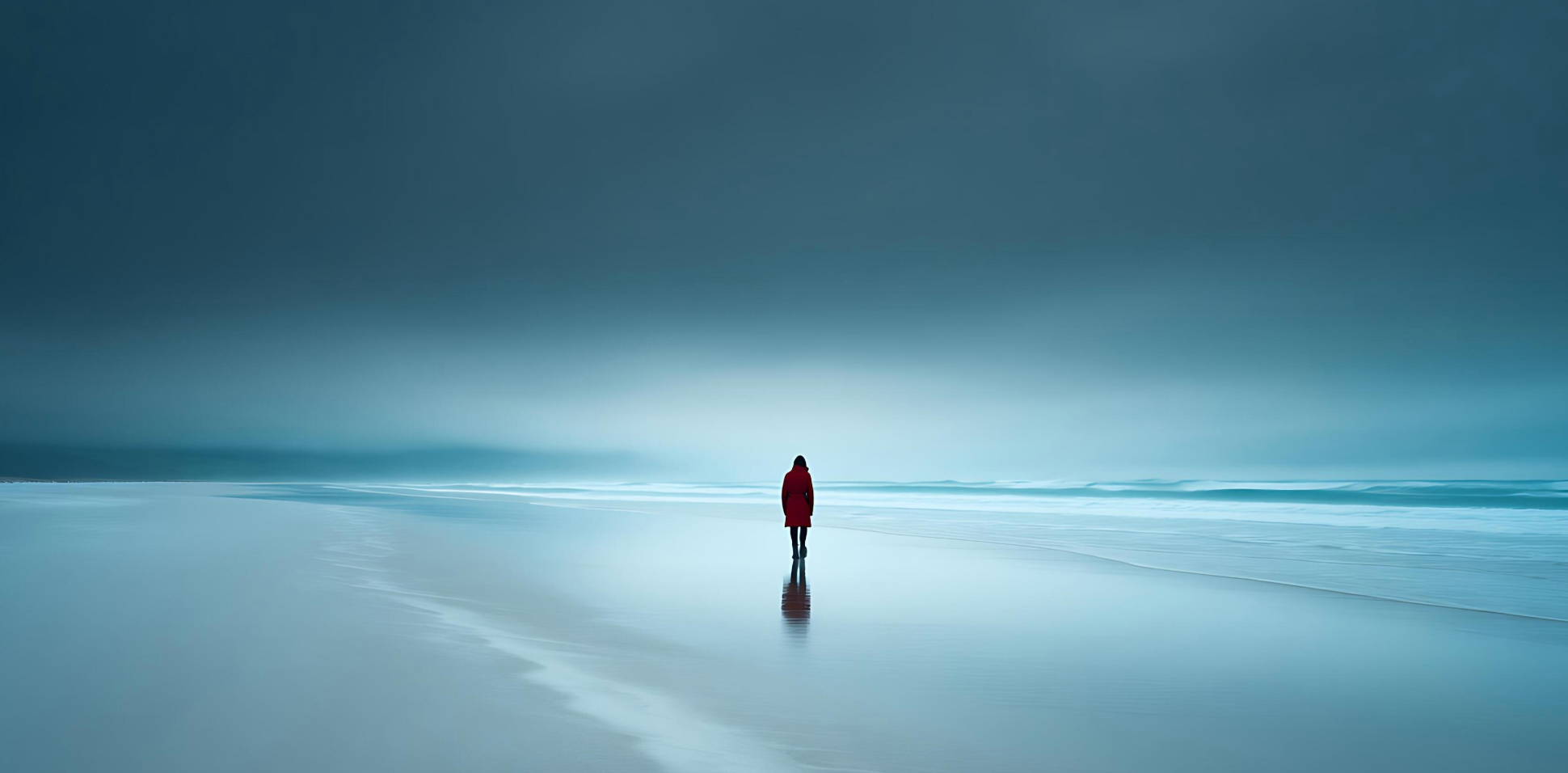 A person stands under a moody blue sky,